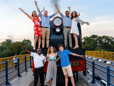 The Tett family posing in front of the train.