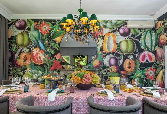 Vibrant private dining room with botanical mural wallpaper and chandelier at Fairlawns Boutique Hotel and Spa, Johannesburg