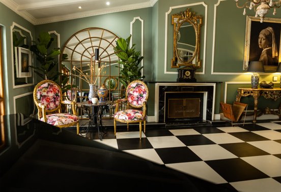 Eclectic piano lounge with gold-framed chairs, fireplace and botanical artwork at Fairlawns Boutique Hotel and Spa, Johannesburg