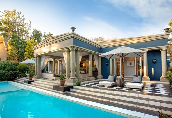 Elegant colonial pool terrace with loungers and colonnade at Fairlawns Boutique Hotel and Spa, Johannesburg
