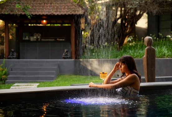 Guest relaxing in a spa pool with waterfall feature at the Fairlawns Boutique Hotel and Spa, Johannesburg