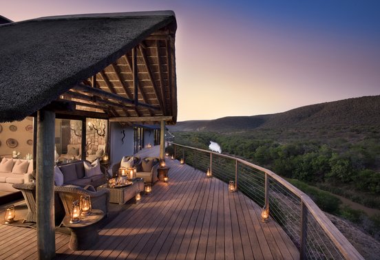 Candlelit deck overlooking the Great Fish River valley at dusk at Kwandwe Great Fish River Lodge, Eastern Cape