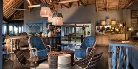 Stylish open-plan guest lounge and bar with African-inspired décor at andBeyond Phinda Mountain Lodge, KwaZulu-Natal
