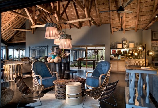 Stylish open-plan guest lounge and bar with African-inspired décor at andBeyond Phinda Mountain Lodge, KwaZulu-Natal