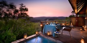 Candlelit private deck dinner for two beside a plunge pool at sunset at andBeyond Phinda Mountain Lodge, KwaZulu-Natal