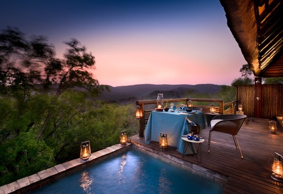 Candlelit private deck dinner for two beside a plunge pool at sunset at andBeyond Phinda Mountain Lodge, KwaZulu-Natal