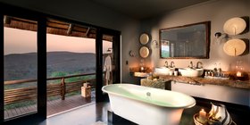 Freestanding soaking tub with panoramic sunset views over Phinda's hills at andBeyond Phinda Mountain Lodge, KwaZulu-Natal