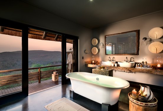 Freestanding soaking tub with panoramic sunset views over Phinda's hills at andBeyond Phinda Mountain Lodge, KwaZulu-Natal
