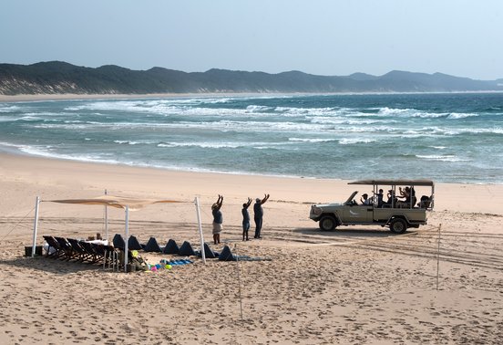 Safari vehicle and guests on the pristine beach at Sodwana Bay, Maputaland coastline, KwaZulu-Natal, South Africa