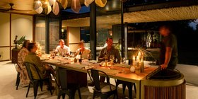 Guests dining by candlelight under sculptural pendant lights at Tanda Tula Safari Camp, Timbavati, South Africa