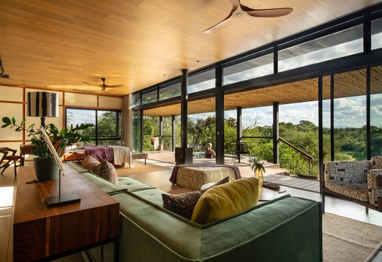 Open-plan luxury suite living area with bush views and private pool deck at Tanda Tula Safari Camp, Timbavati