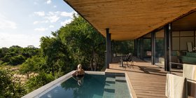 Guest relaxing in a private infinity plunge pool overlooking the Timbavati bush at Tanda Tula Safari Camp