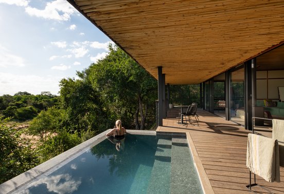 Guest relaxing in a private infinity plunge pool overlooking the Timbavati bush at Tanda Tula Safari Camp