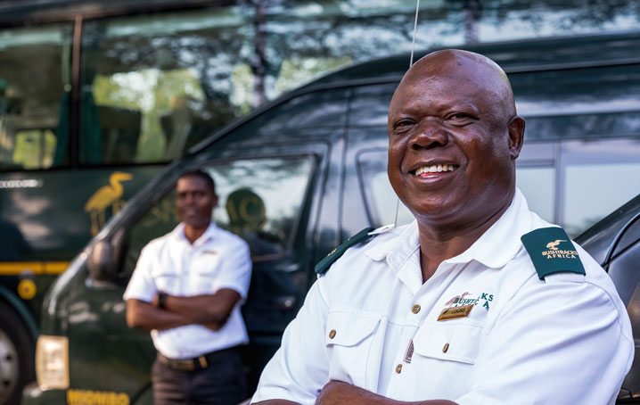 Bushtracks Africa staff in front of BTA vehicles.