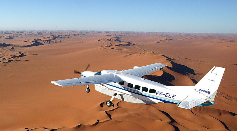Plane flying over the desert in Africa.