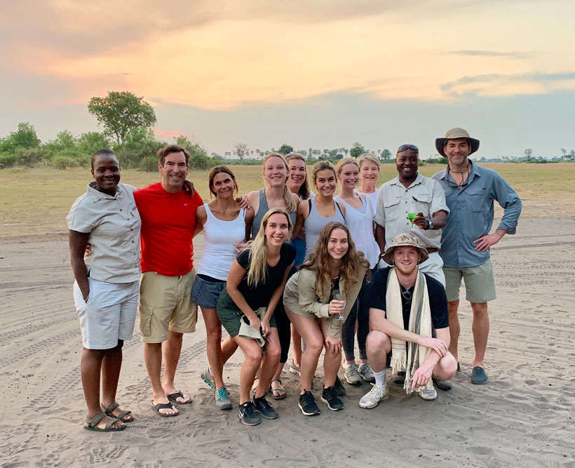 A family on safari in the sunset.