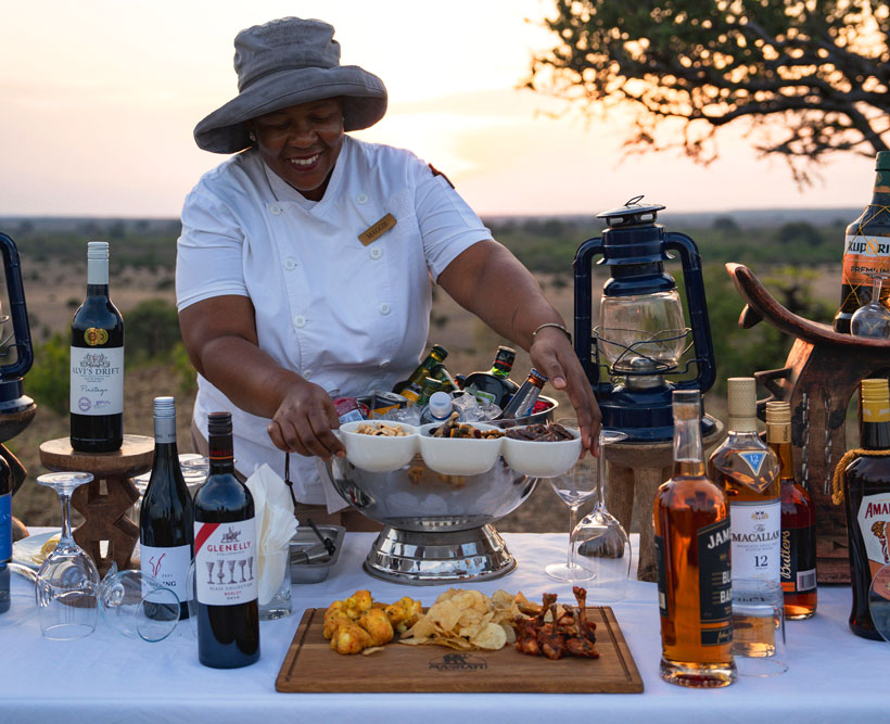 A nice lady serving drinks and snacks during sundowners.