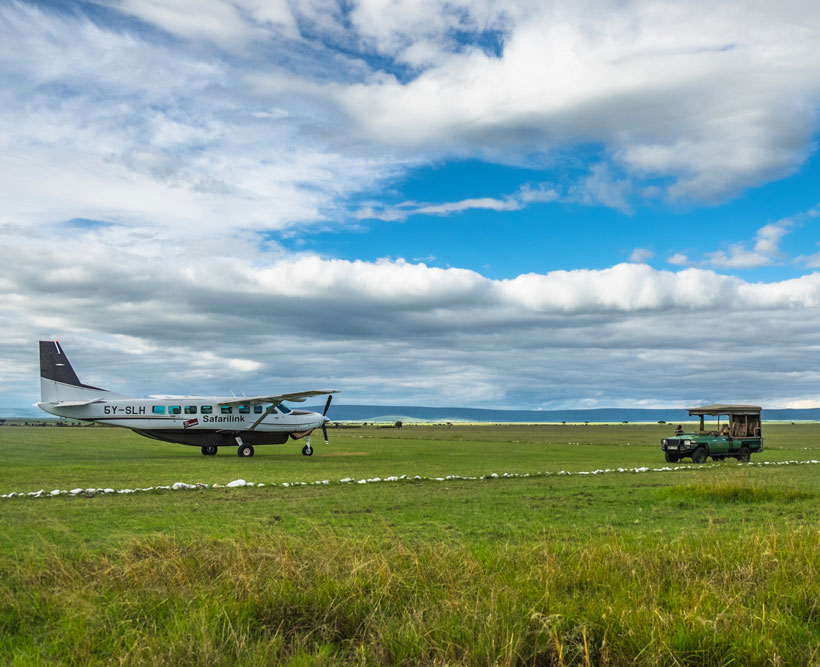 Camp vehicle meeting a Cessna in on the runway.