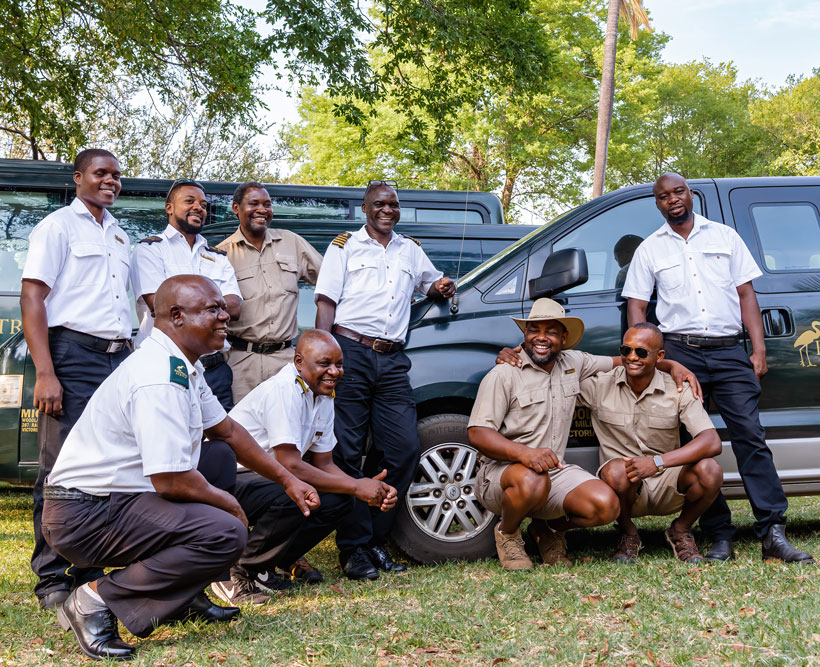 The Bushtracks Africa staff in front of Bushtracks vehicles.