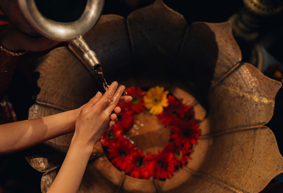 A woman washing hands at Darwikas Hotel.