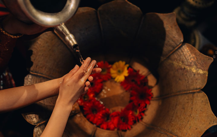 A woman washing her hands at Darwika's Hotel