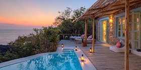 Sunset view from a private villa with plunge pool and deck overlooking Lake Malawi at Kaya Mawa on Likoma Island.