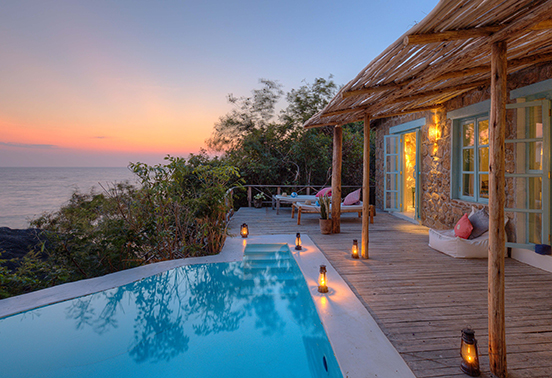 Sunset view from a private villa with plunge pool and deck overlooking Lake Malawi at Kaya Mawa on Likoma Island.
