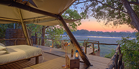Open-fronted tented suite at Shawa Luangwa Camp overlooking the Luangwa River at sunrise, South Luangwa National Park.
