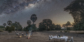 Dining under the Milky Way at a lantern-lit bush dinner arranged by Sausage Tree Camp in Lower Zambezi National Park.