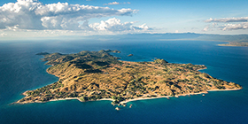 Aerial view of Likoma Island surrounded by the deep blue waters of Lake Malawi, home to Kaya Mawa lodge.