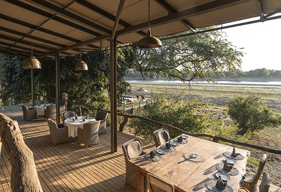 Open-air dining deck at Shawa Luangwa Camp set above the Luangwa River in South Luangwa National Park.