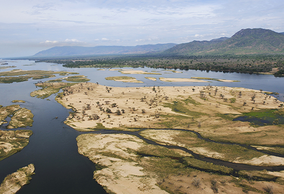Aerial view of the Zambezi River and its sandy islands winding through Lower Zambezi National Park, Zambia.