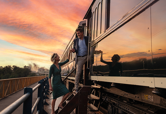 Guests boarding the Royal Livingstone Express at sunset near Victoria Falls, Zambia
