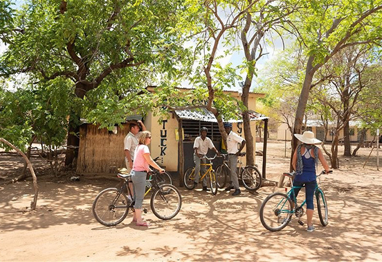 Guests on a bicycle tour through the Lesoma Valley near Chobe National Park, Botswana